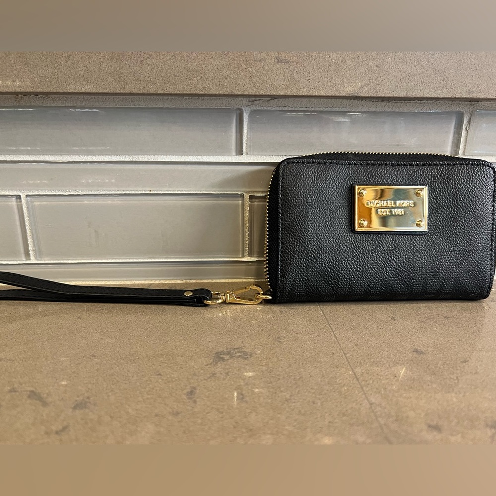 Michael Kors wristlet. 6 inches long by 4 inches tall. Gold accents.